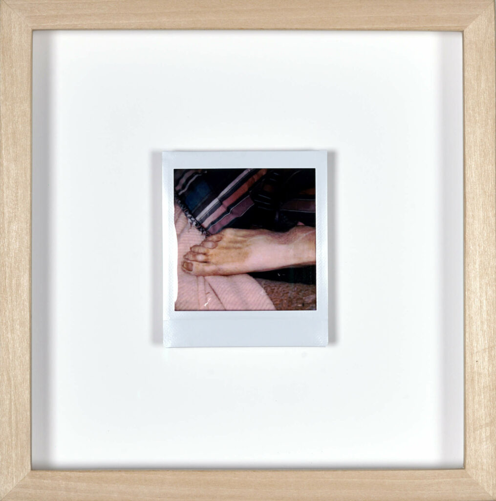 Photo taken by artist Clayton Porter of his father’s body—postmortem—framed under glass in maple.