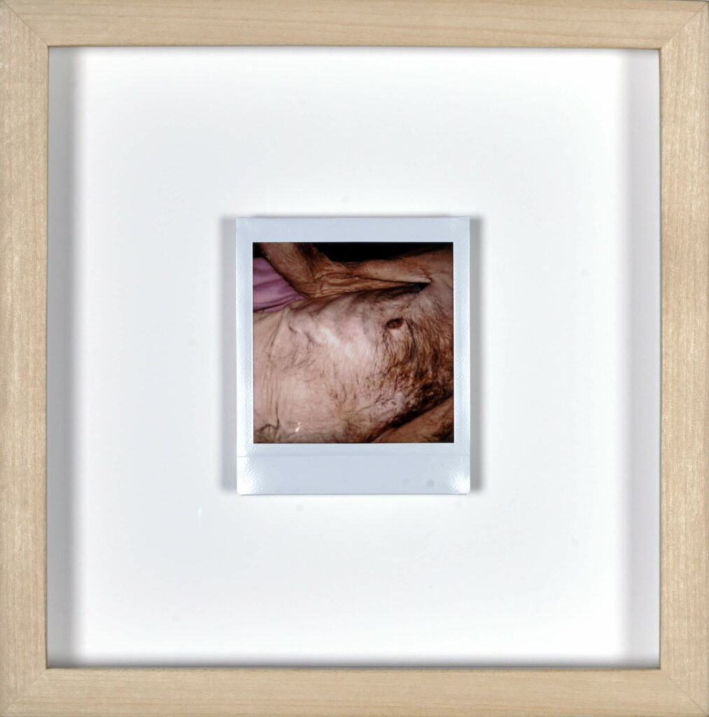 Photo taken by artist Clayton Porter of his father’s body—postmortem—framed under glass in maple.