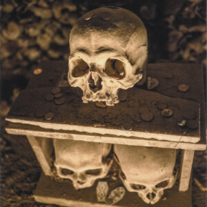 Skull on top of a guardian house kept by the anime pezzentelle cult at the Cimitero delle Fontanelle ossuary in Napoli Italy.