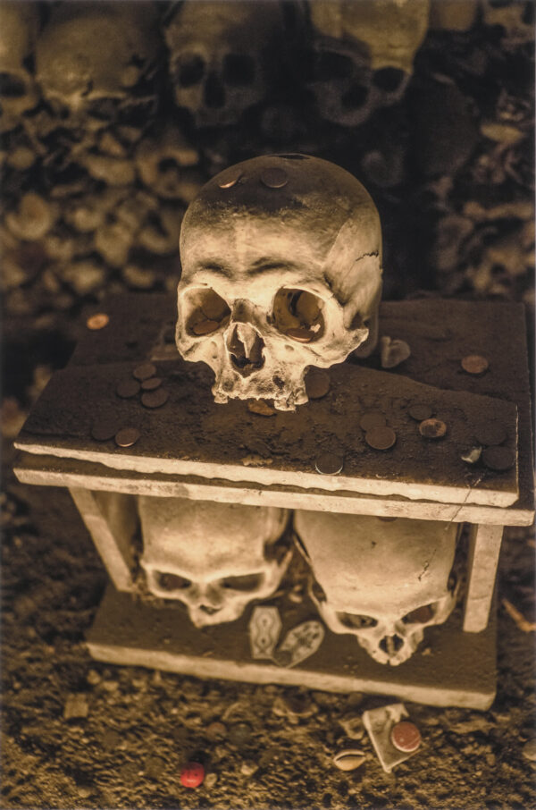 Skull on top of a guardian house kept by the anime pezzentelle cult at the Cimitero delle Fontanelle ossuary in Napoli Italy.